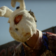 The Forever Purge first trailer screenshot of a man covered in blood wearing a large, creepy bunny mask.